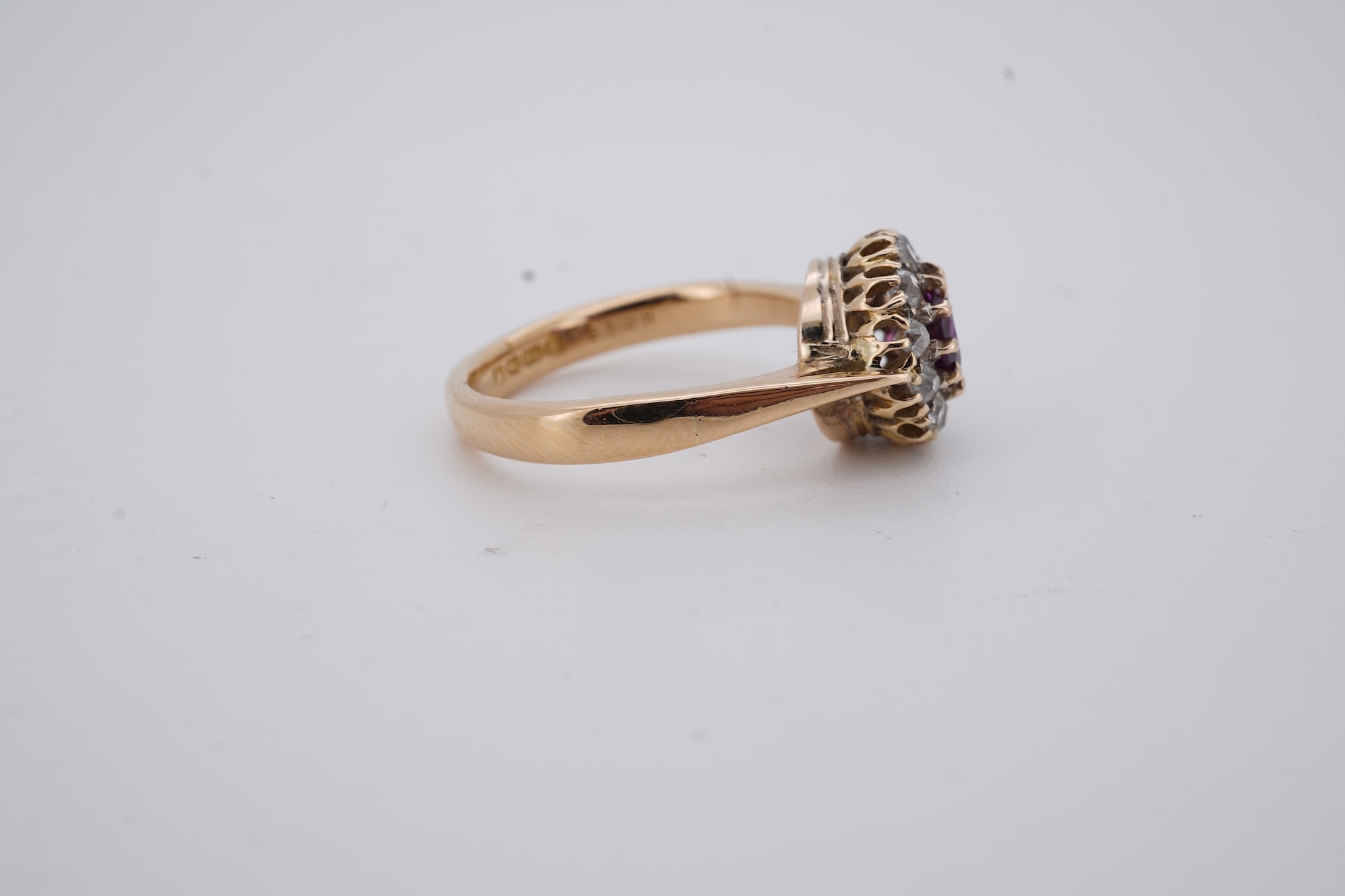 A George V 18ct gold, ruby and diamond set circular cluster ring, size M, gross weight 5 grams.